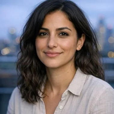Woman in her early thirties, wavy dark hair, olive skin, calm expression
